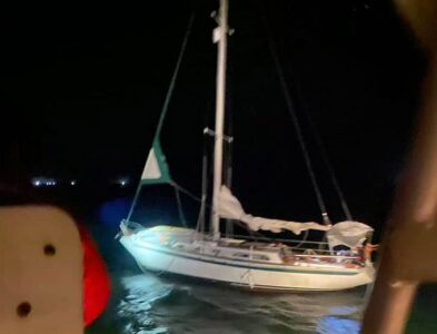 Illuminating flares help vessel tow across bar at night