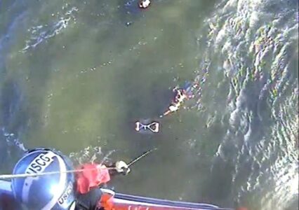 Two men in water spotted thanks to flares