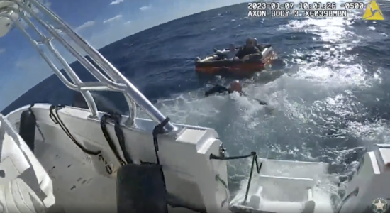 Flare guides rescuers to crew after boat sinks