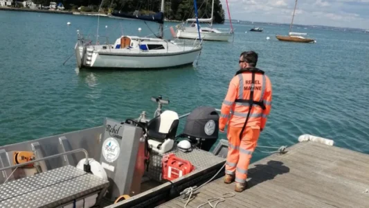 Man in water uses flare and is rescued by ferry crew
